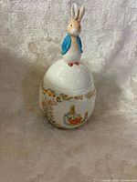 Full view of closed jar showing bunny finial and side graphics