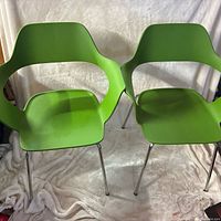 Front view of both green molded chairs on chrome legs