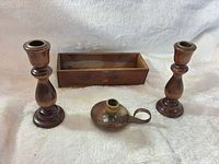 All four items: two wooden candlesticks, brass chamberstick, wooden box