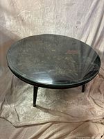 Top view of round chinoiserie coffee table with glass top