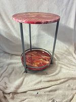 Full view of table showing resin top, metal frame and lower shelf