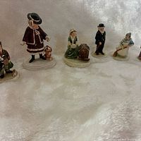 Group shot of six miniature figurines lined up