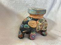 Front left view of painted porcelain elephant plant stand