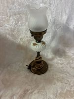 Full view of lamp showing shade, glass body, and base