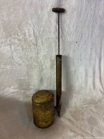 Full view of brass oil can with pump rod extended