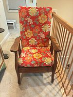 front view of oak folding armchair, floral upholstery