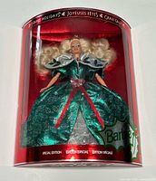 Front view of boxed 1995 Happy Holidays Barbie showing full doll and packaging graphics