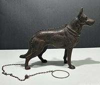 Full side view showing complete doorstop, chain, and ring