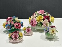 Group shot of all five bone china floral arrangements
