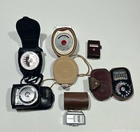 All six light meters displayed with cases