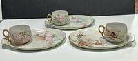 All three plate and cup sets displayed