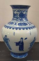 Full view of vase front showing figural scene and decorative band