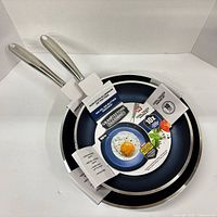 Both fry pans nested with packaging intact