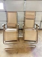 Front view of both zero-gravity chairs folded out showing overall design and condition