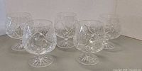 All five cut crystal snifter glasses grouped