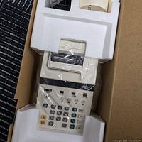 Calculator in styrofoam with plastic wrap