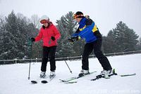 Promotional photo of two skiers on slope