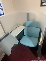 Workstation partially disassembled showing chair, privacy panels, work surfaces