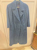Full front view of blue long peacoat on hanger