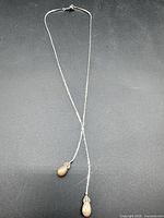 Full view of D'Orlan lariat necklace showing overall length and twin drops