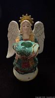 Front view of angel candle holder showing full figure and candle well
