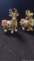 Front view of both ceramic reindeer shakers