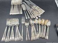 Full layout of flatware showing forks, knives, spoons and spreaders