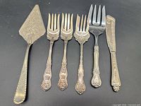 Group shot of six flatware pieces on black background