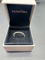 Pandora ring in branded box, lid open showing interior