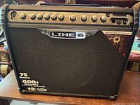 Front view showing Line 6 logo, 75 Watts, 400+ presets, 12 inch Celestion speaker