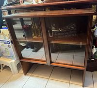 Front view of wood display hutch with glass doors