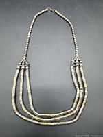 Full view of three-strand sterling silver bead necklace