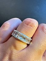 Ring on finger showing overall design and stones