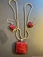 Full view of necklace with pendant and earrings