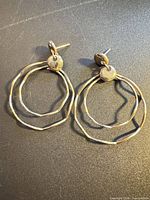 Front view of both earrings showing double hoops and stud tops