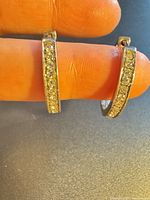 Front view of both sterling silver hoops showing row of clear stones