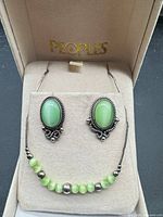 Full view of necklace and earrings in Peoples box