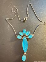 Full view of sterling chain and blue stone pendant