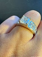 Ring on finger showing full band and stones