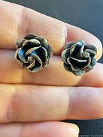 Front view of both rose stud earrings showing design and patina