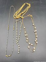 Overview of four vintage necklaces laid out
