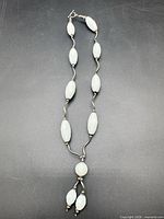 Full view of necklace showing bead arrangement and drop