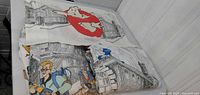 Folded Ghostbusters twin blanket displaying character art and cityscape