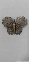 Front view of filigree butterfly brooch