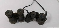 Both binoculars side by side showing general condition