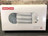 Sealed retail box front showing brand, window with sheet prints visible.