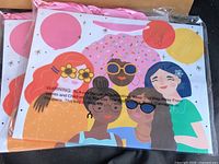 Front view of gift bags with illustration and handles visible