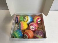 Open gift box showing eight multicolour bath bombs