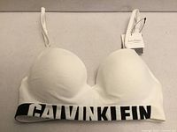 Front view showing entire bra, logo band, tags
