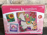 Front of sealed box showing product name, age rating, sample designs
